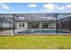 A screened-in pool with a spa and lush landscaping for outdoor enjoyment and relaxation at 17555 Glistening Ct, Venice, FL 34293