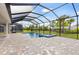 Screened-in pool with spa and brick paver decking offering a private outdoor oasis at 17555 Glistening Ct, Venice, FL 34293