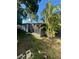 Backyard view of home with a screened in sunroom and mature trees at 1782 Michigan Ne Ave, St Petersburg, FL 33703