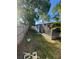 Backyard view of home with a screened in sunroom and a fenced yard at 1782 Michigan Ne Ave, St Petersburg, FL 33703