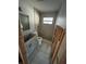 This renovated bathroom features new vanity, toilet, and partial shower with pebble flooring at 1782 Michigan Ne Ave, St Petersburg, FL 33703