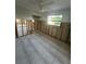 Spacious bedroom features gray ceramic tile, partial walls and large window with neighborhood views at 1782 Michigan Ne Ave, St Petersburg, FL 33703