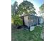 Rear exterior view of home with a screened in sunroom and mature trees at 1782 Michigan Ne Ave, St Petersburg, FL 33703