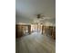 Wide shot of living room features gray ceramic tile, partial walls leading into kitchen and bathroom at 1782 Michigan Ne Ave, St Petersburg, FL 33703