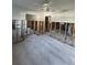 Wide shot of living room features gray ceramic tile, partial walls and ceiling fan at 1782 Michigan Ne Ave, St Petersburg, FL 33703