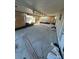 Bright sunroom with ceiling fan and roll down shades awaiting renovation with a concrete floor and natural lighting at 1782 Michigan Ne Ave, St Petersburg, FL 33703