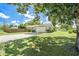 Exterior showcasing a well-maintained yard, carport, and a neatly painted home at 1857 N Belleair N Rd, Clearwater, FL 33764
