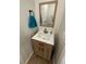 Charming powder room featuring a wood-framed mirror and a modern vanity with a bright white countertop at 1935 Oxnard Ct, Tampa, FL 33612