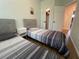 Bedroom featuring two cozy twin beds, matching nightstands, and a closet with open doors at 1935 Oxnard Ct, Tampa, FL 33612