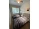 Bright bedroom featuring two comfortable twin beds, a window, and warm, natural light at 1935 Oxnard Ct, Tampa, FL 33612