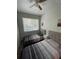 Bright bedroom featuring two comfortable twin beds, a window, and warm, natural light at 1935 Oxnard Ct, Tampa, FL 33612
