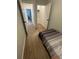 Bedroom with a twin bed featuring a striped bedspread and views of a closet and a hallway at 1935 Oxnard Ct, Tampa, FL 33612