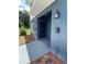 Eye-level view of a townhome entryway with a dark blue door, mailbox, and exterior light fixture at 1935 Oxnard Ct, Tampa, FL 33612