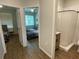 Hallway with rooms and a full bathroom; bedroom features two twin beds and natural light from the window at 1935 Oxnard Ct, Tampa, FL 33612