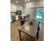 Eat-in kitchen with stainless steel appliances, white cabinets, granite countertops and adjacent dining area at 1935 Oxnard Ct, Tampa, FL 33612