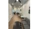 Spacious living room with modern furniture and wood-look flooring flows seamlessly into the dining area at 1935 Oxnard Ct, Tampa, FL 33612