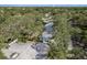 Aerial view of a neighborhood featuring mature trees and light blue single-Gathering homes with fenced yards at 1949 Kings Hwy, Clearwater, FL 33755