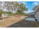 Expansive backyard featuring well-placed palm trees, an outdoor patio, and an outdoor seating area at 1949 Kings Hwy, Clearwater, FL 33755