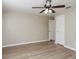 Spacious bedroom featuring wood-look floors, neutral walls, and ceiling fan at 1949 Kings Hwy, Clearwater, FL 33755