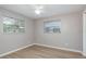 Bright bedroom with wood-look floors and dual windows for natural light at 1949 Kings Hwy, Clearwater, FL 33755