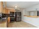 Functional kitchen with stainless steel appliances, tiled flooring, and a breakfast bar overlooking the living area at 1949 Kings Hwy, Clearwater, FL 33755