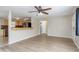 Open-concept living area with modern flooring, connecting to a kitchen area, offering a seamless flow at 1949 Kings Hwy, Clearwater, FL 33755