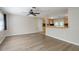 Bright living room featuring neutral walls, wood-look flooring, and a ceiling fan at 1949 Kings Hwy, Clearwater, FL 33755