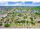 Aerial view showcases a neighborhood with mature trees, ponds, and streets leading to the home's location at 201 83Rd N Ave, St Petersburg, FL 33702