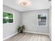 Neutral bedroom boasts gray walls, wood-look flooring, and great natural light, creating a calming atmosphere at 201 83Rd N Ave, St Petersburg, FL 33702