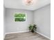 Well-lit bedroom provides a tranquil space with wood-look floors, neutral paint, and a modern ceiling fan at 201 83Rd N Ave, St Petersburg, FL 33702