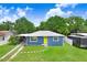 Well-maintained home featuring a bright yellow door and a lush green lawn at 201 83Rd N Ave, St Petersburg, FL 33702