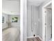 Hallway featuring wood-look floors and neutral paint, leading to open rooms and convenient laundry access at 201 83Rd N Ave, St Petersburg, FL 33702