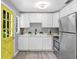 Updated kitchen features white cabinetry, stainless steel appliances, and a bright door at 201 83Rd N Ave, St Petersburg, FL 33702