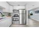 Modern kitchen boasts stainless steel appliances, ample counter space, and white cabinets at 201 83Rd N Ave, St Petersburg, FL 33702