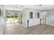 Spacious living room with hardwood floors, large windows overlooking the backyard at 201 83Rd N Ave, St Petersburg, FL 33702