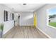 Modern living room features hardwood floors, updated lighting, and a bright yellow door at 201 83Rd N Ave, St Petersburg, FL 33702