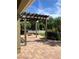 Brick patio featuring a wooden pergola, fire pit, and lush landscaping in a private backyard setting at 20101 Oakflower Ave, Tampa, FL 33647