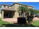 Lush backyard featuring tropical landscaping, brick patio, and a two-story home at 20101 Oakflower Ave, Tampa, FL 33647