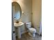 Small bathroom features a pedestal sink and toilet on tile floors with neutral colored walls at 20101 Oakflower Ave, Tampa, FL 33647