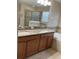 Bathroom with a double sink granite countertop and a tiled backsplash at 20101 Oakflower Ave, Tampa, FL 33647