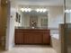 Bathroom with granite counter, double sinks, and tile floors at 20101 Oakflower Ave, Tampa, FL 33647