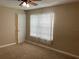 Bedroom with a window and a ceiling fan, neutral walls, and carpet at 20101 Oakflower Ave, Tampa, FL 33647