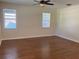 Spacious bedroom with wood floors, neutral walls, and two windows with blinds at 20101 Oakflower Ave, Tampa, FL 33647