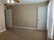 Bedroom with a window, carpeted floor, and two white doors at 20101 Oakflower Ave, Tampa, FL 33647