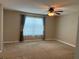 Cozy bedroom with carpet, window with curtains and ceiling fan at 20101 Oakflower Ave, Tampa, FL 33647