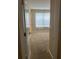 Bedroom with tan carpet and a window, viewed from the doorway at 20101 Oakflower Ave, Tampa, FL 33647