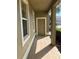 Covered front porch offers a brick floor leading up to the taupe colored front door at 20101 Oakflower Ave, Tampa, FL 33647