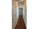 Hallway with wood flooring leading to bedroom with natural light at 20101 Oakflower Ave, Tampa, FL 33647