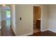 Hallway with wood flooring leading to a bathroom and a room at 20101 Oakflower Ave, Tampa, FL 33647