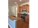 Modern kitchen features stainless steel appliances, granite countertops, and wood cabinets at 20101 Oakflower Ave, Tampa, FL 33647